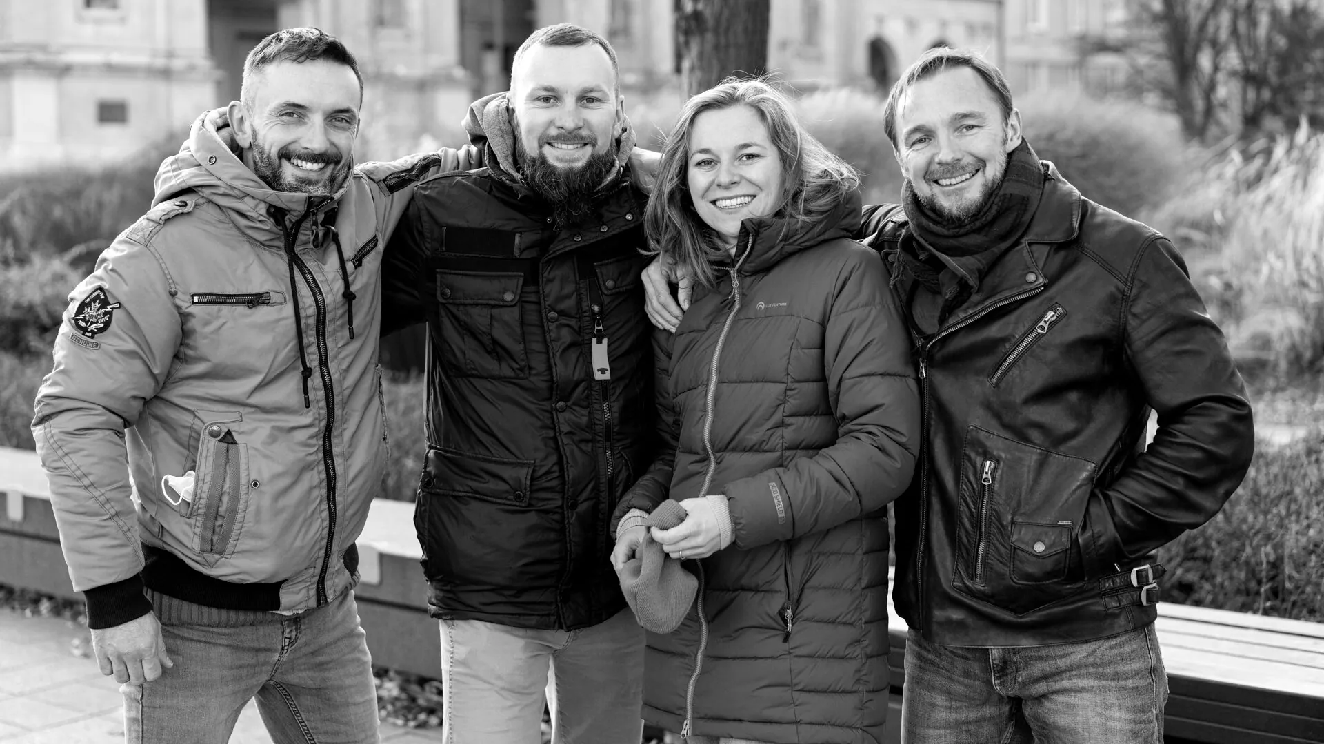 Four Saario Academy instructors shoulder to shoulder on a winter street in Warsaw — the team behind the standard